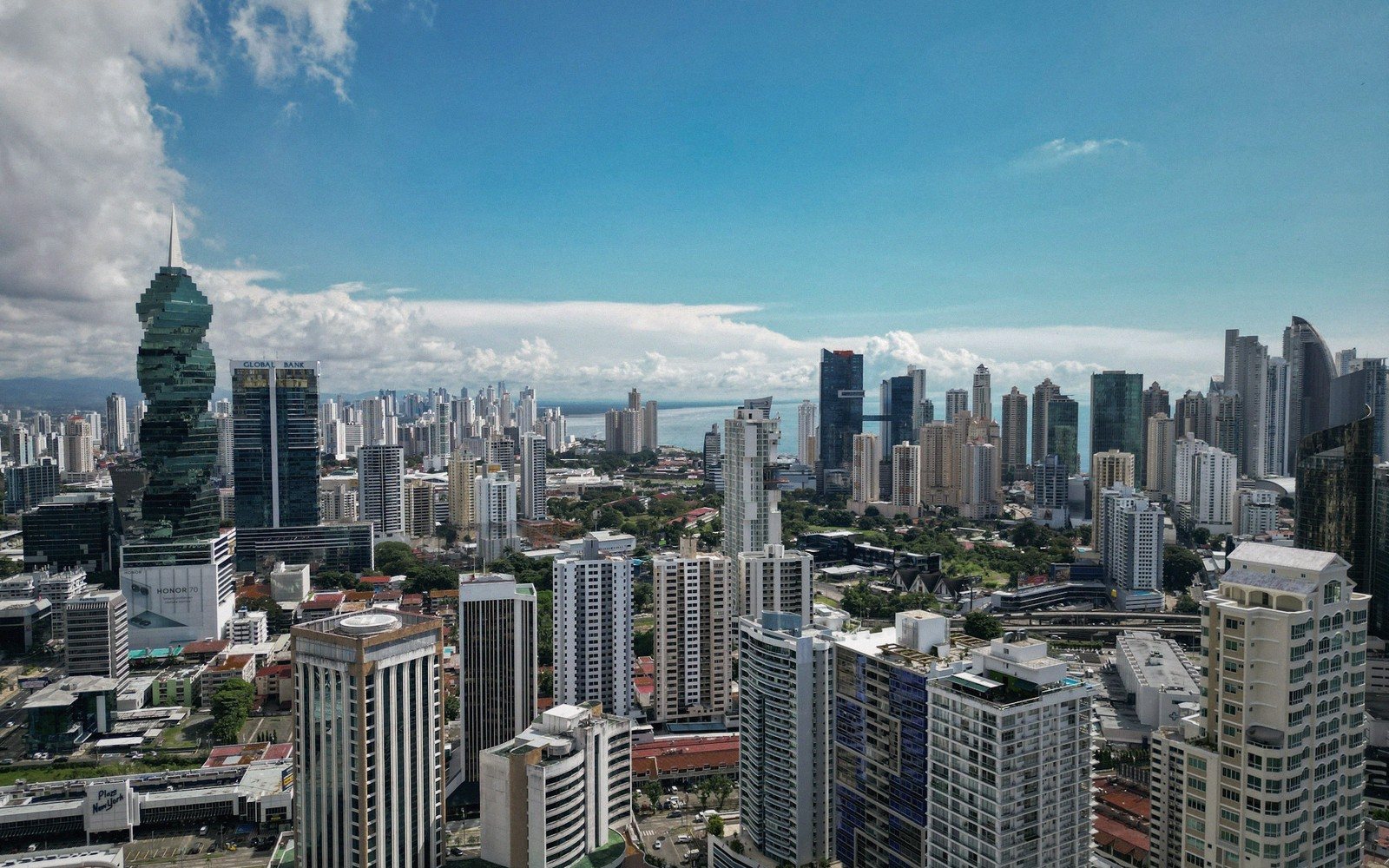 Panama City's skyline with the spiral Revolution Tower rising above dense high-rises near the coast